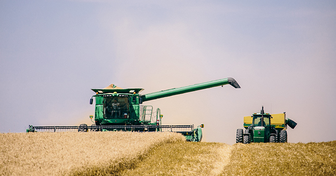 FHSU combine harvesting wheat